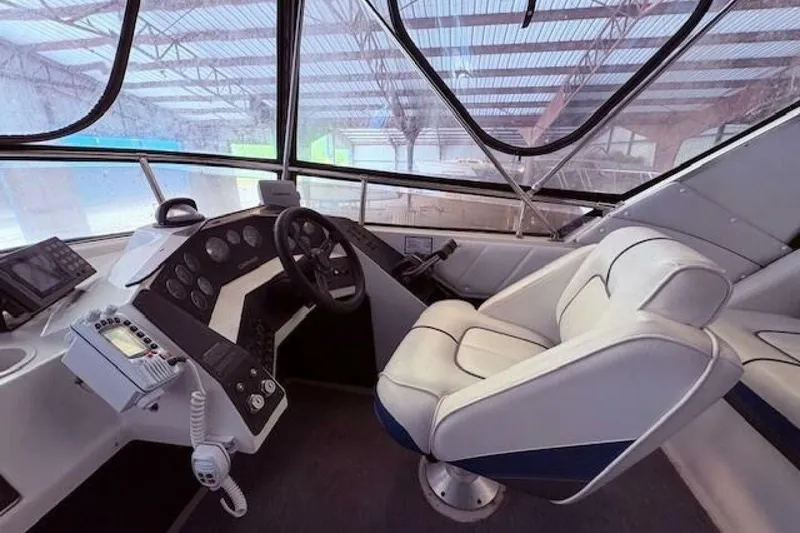 Slide: The Image of Interior cockpit of a 1991 Carver 3067 Santego boat with steering wheel and controls. - 11