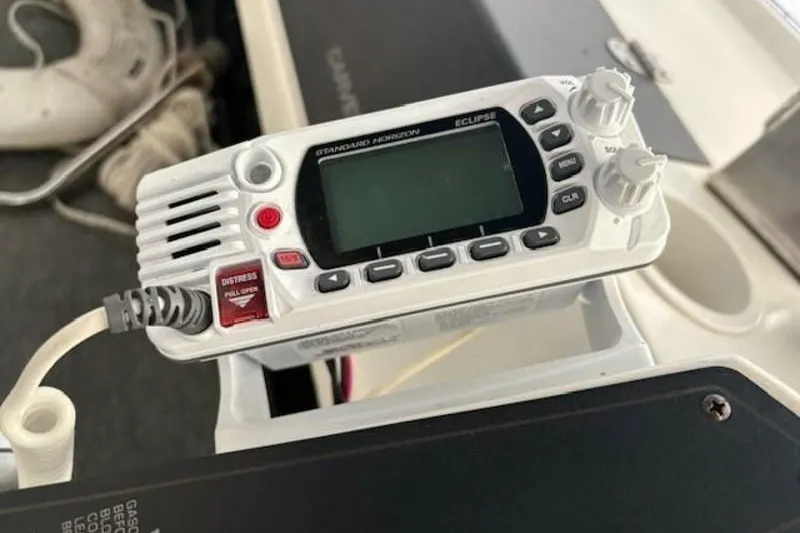 Slide: The Image of Marine radio on 1991 Carver 3067 Santego boat dashboard, featuring distress button. - 14