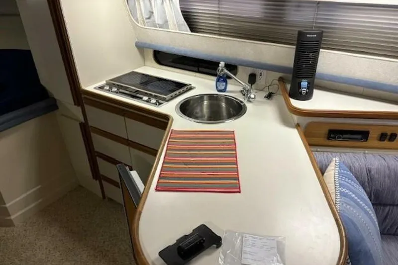 Slide: The Image of Interior of 1991 Carver 3067 Santego yacht with kitchenette, stove, sink, and seating area. - 20