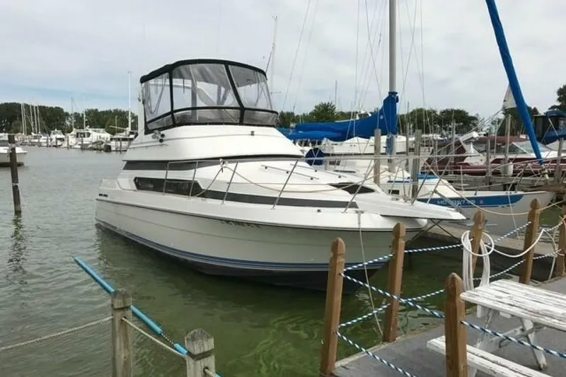 The Image of 1991 Carver 3067 Santego yacht docked at a marina, surrounded by other boats. - 1