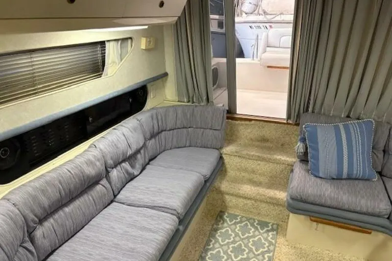 Slide: The Image of Interior of a 1991 Carver 3067 Santego yacht with gray seating and patterned rug. - 16