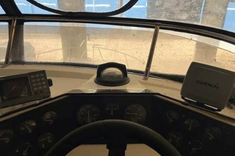 Slide: The Image of Interior view of 1991 Carver 3067 Santego boat cockpit with Garmin navigation system. - 13