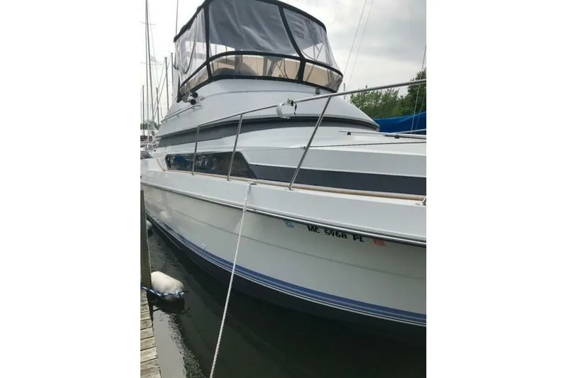 Slide: The Image of 1991 Carver 3067 Santego yacht docked, featuring sleek design and spacious cabin. - 3