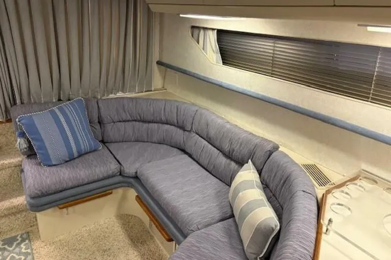 Slide: The Image of Interior of 1991 Carver 3067 Santego yacht with cozy blue seating area. - 17