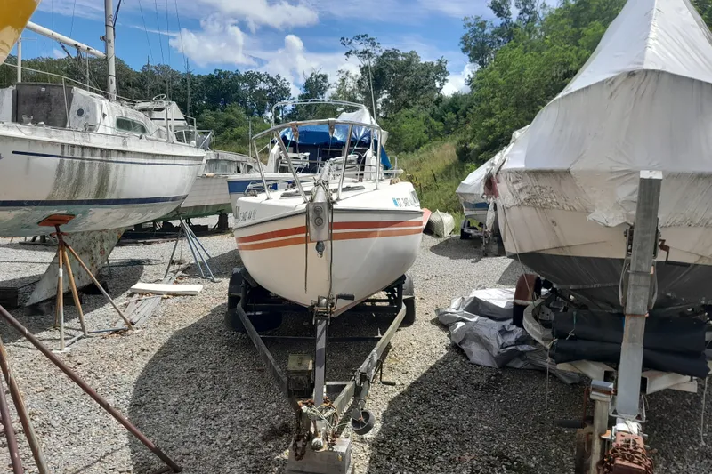 Slide: The Image of 1979 Clark San Juan sailboat on trailer, surrounded by other boats in a storage yard. - 4
