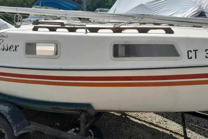 Slide: The Image of 1979 Clark San Juan sailboat with orange stripes on a trailer. - 3