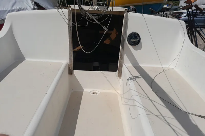 Slide: The Image of 1979 Clark San Juan sailboat cockpit with open hatch and visible rigging. - 7