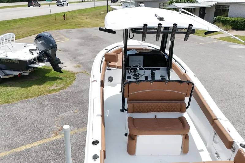 Slide: The Image of 2027 Sea Hunt Ultra 235 SE boat with Yamaha engine, parked on pavement. - 8