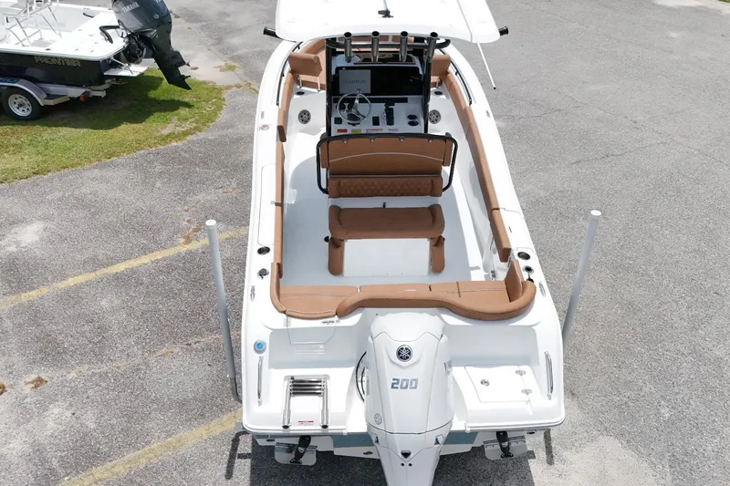 Slide: The Image of 2027 Sea Hunt Ultra 235 SE boat with Yamaha engine, aerial view, parked on pavement. - 11