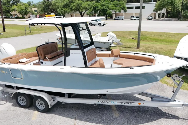 Slide: The Image of 2027 Sea Hunt Ultra 235 SE boat on trailer, featuring sleek design and spacious seating. - 12