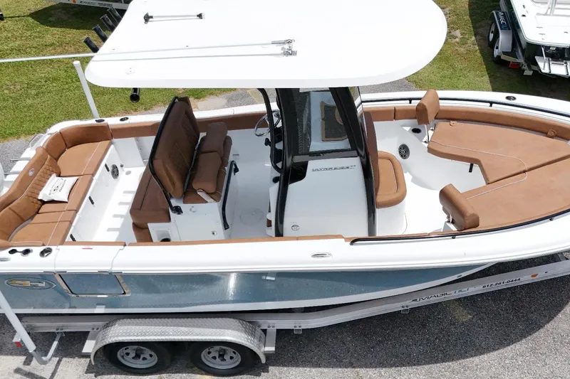 Slide: The Image of 2027 Sea Hunt Ultra 235 SE boat with brown seating, white deck, and dual-axle trailer. - 5
