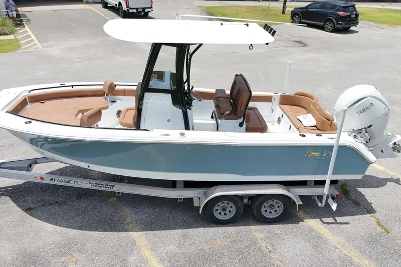 Slide: The Image of 2027 Sea Hunt Ultra 235 SE boat on trailer, featuring sleek design and Yamaha engine. - 10