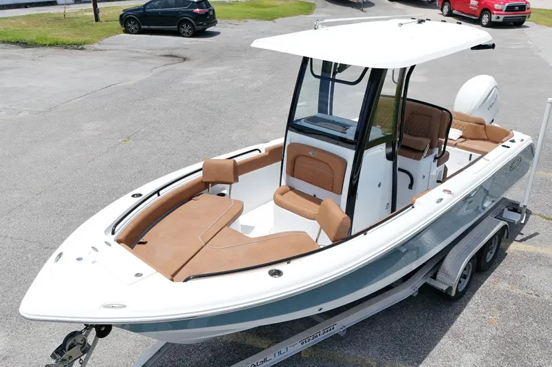 Slide: The Image of 2027 Sea Hunt Ultra 235 SE boat on trailer, featuring sleek design and spacious seating. - 2