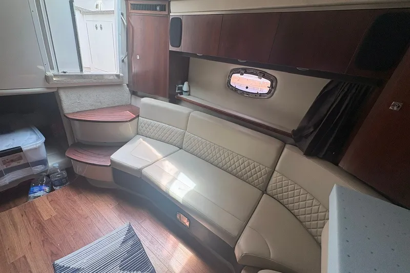 Slide: The Image of Interior of 2015 Chaparral 310 Signature yacht with beige seating and wooden accents. - 7