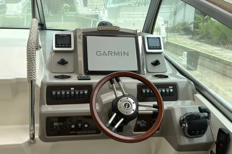 Slide: The Image of Helm of 2015 Chaparral 310 Signature with Garmin navigation system and wooden steering wheel. - 12