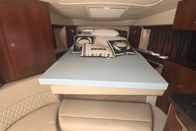 Slide: The Image of Interior of 2015 Chaparral 310 Signature boat with cozy bed and nautical decor. - 8