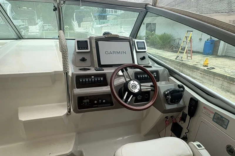 Slide: The Image of Cockpit of 2015 Chaparral 310 Signature with Garmin navigation system and steering wheel. - 13