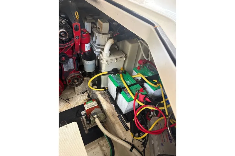 Slide: The Image of Engine compartment of a 2015 Chaparral 310 Signature boat with batteries and wiring. - 18