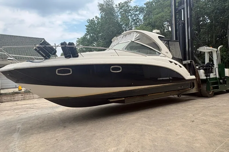 Slide: The Image of 2015 Chaparral 310 Signature boat lifted by forklift, outdoors. - 3