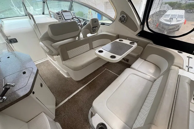 Slide: The Image of 2015 Chaparral 310 Signature boat interior with seating and table setup. - 15