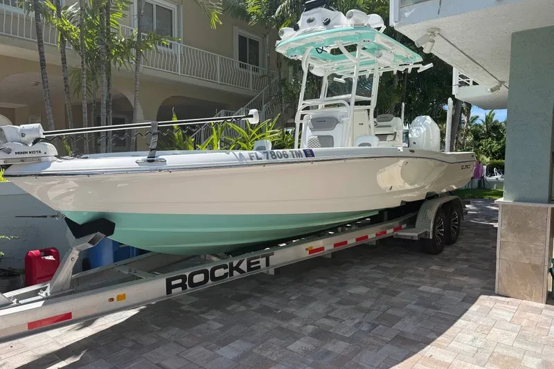 The Image of 2023 Caymas 281 HB boat on a Rocket trailer, parked in a driveway. - 1