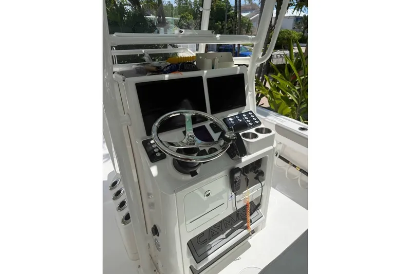 Slide: The Image of 2023 Caymas 281 HB boat helm with steering wheel, controls, and display screens. - 5
