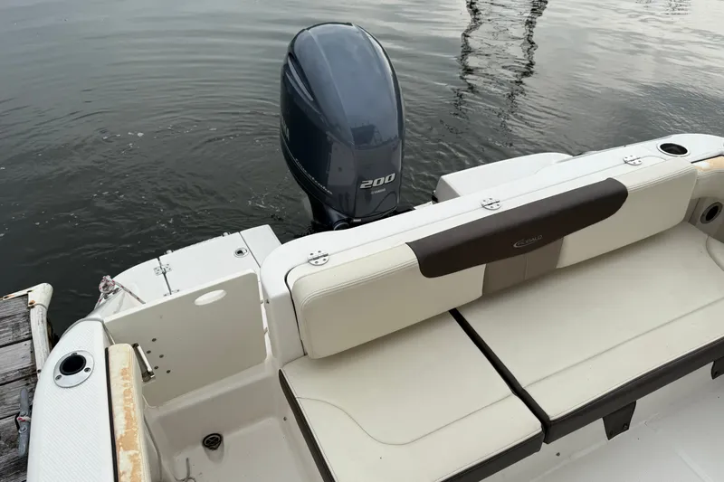 Slide: The Image of 2019 Robalo R222 Explorer boat with Yamaha 200 engine, docked on calm water. - 4