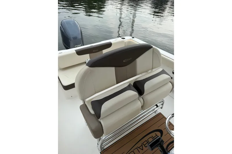Slide: The Image of 2019 Robalo R222 Explorer boat interior with cushioned seating and outboard motor. - 7