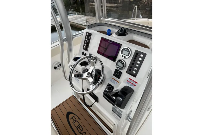 Slide: The Image of 2019 Robalo R222 Explorer boat dashboard with steering wheel and control panel. - 6