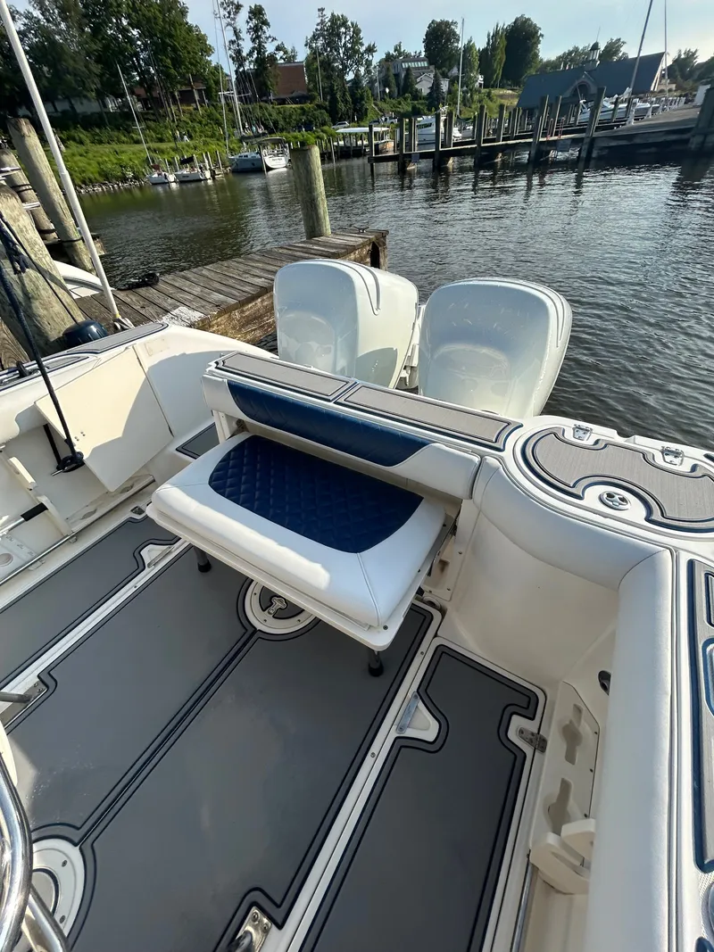 Slide: The Image of The image shows the stern of a 2004 Boston Whaler 270 Outrage docked at a pier. - 8
