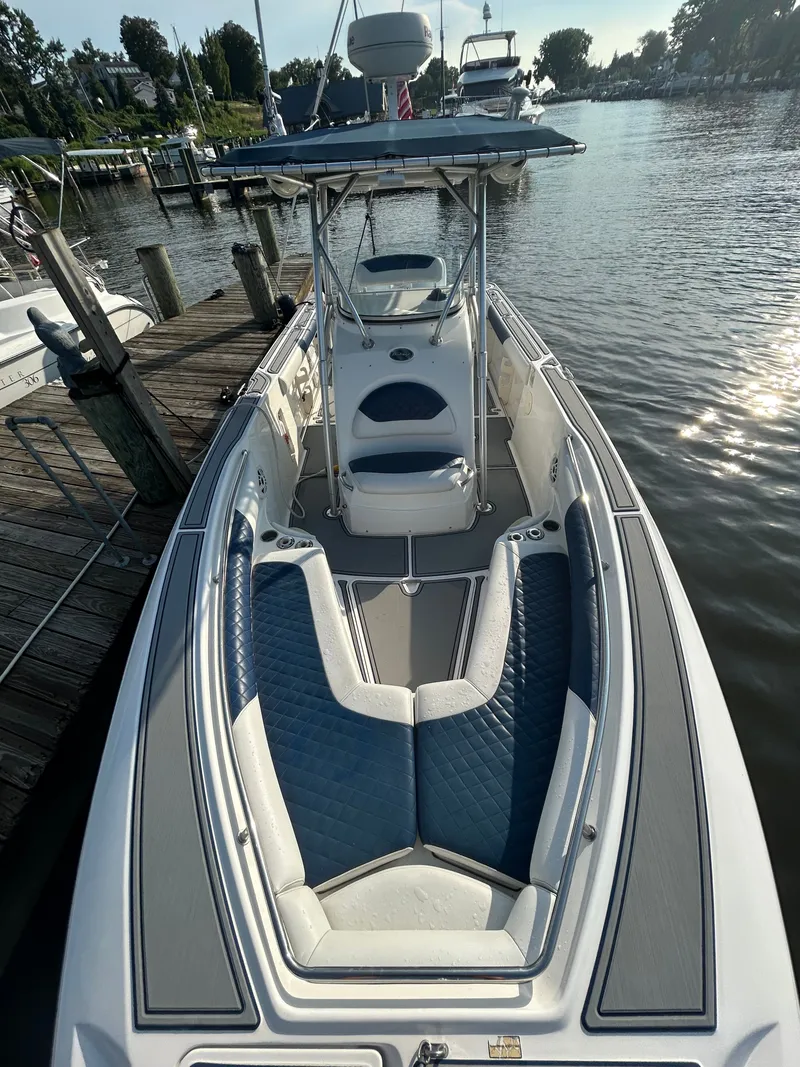 Slide: The Image of A 2004 Boston Whaler 270 Outrage docked. It features blue and white upholstery. - 5