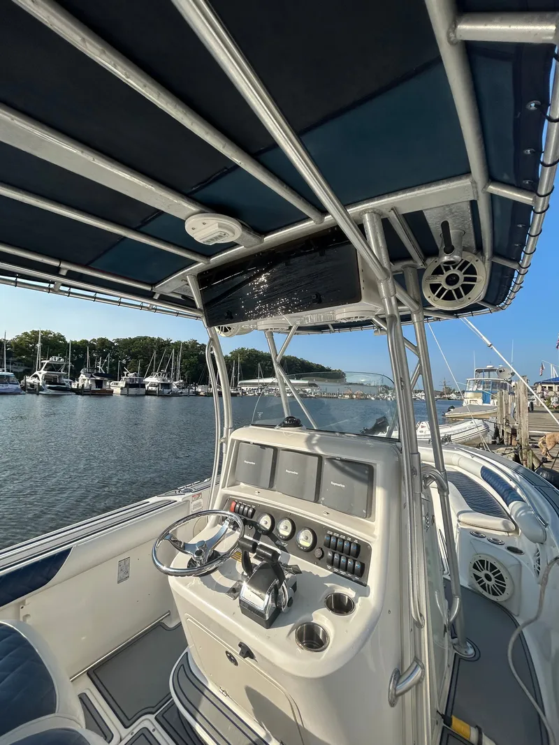 Slide: The Image of The image shows the cockpit of a 2004 Boston Whaler 270 Outrage with helm and instruments. - 9