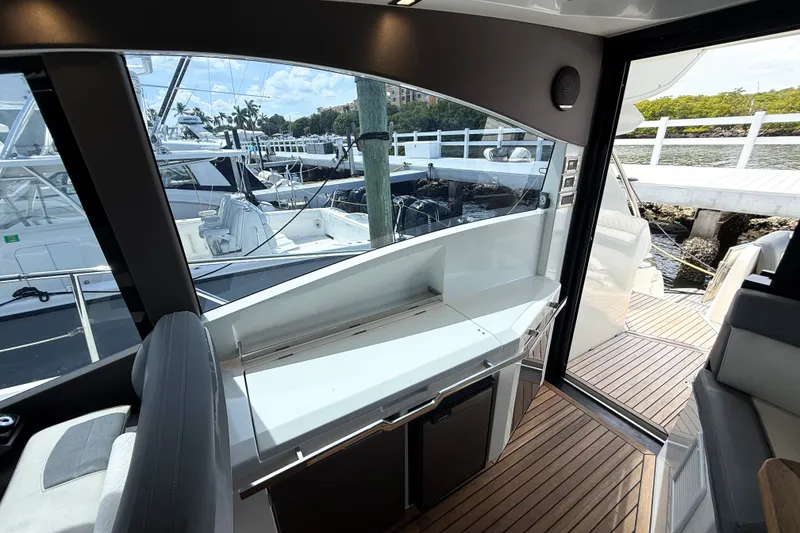 Slide: The Image of Interior view of 2019 Galeon 485 HTS yacht with marina backdrop. - 8