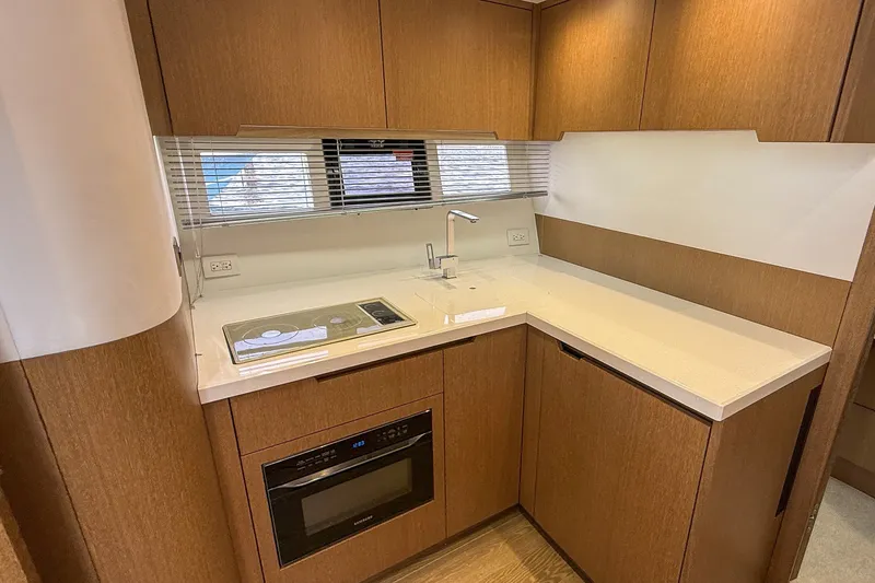 Slide: The Image of Modern kitchen interior of 2019 Galeon 485 HTS yacht with sleek wood cabinetry. - 17