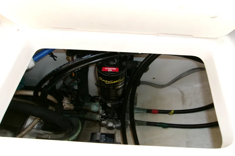 Slide: The Image of 2010 Robalo R240 Center Console boat engine compartment with hoses and wiring. - 37