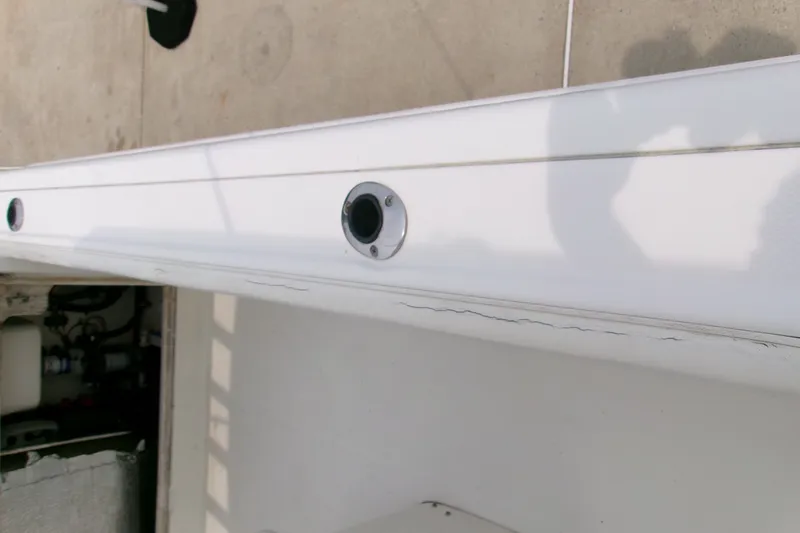 Slide: The Image of 2010 Robalo R240 Center Console boat with visible surface cracks. - 49