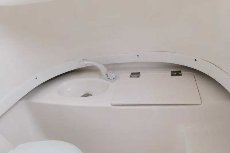 Slide: The Image of 2010 Robalo R240 Center Console boat interior sink and storage compartment. - 36
