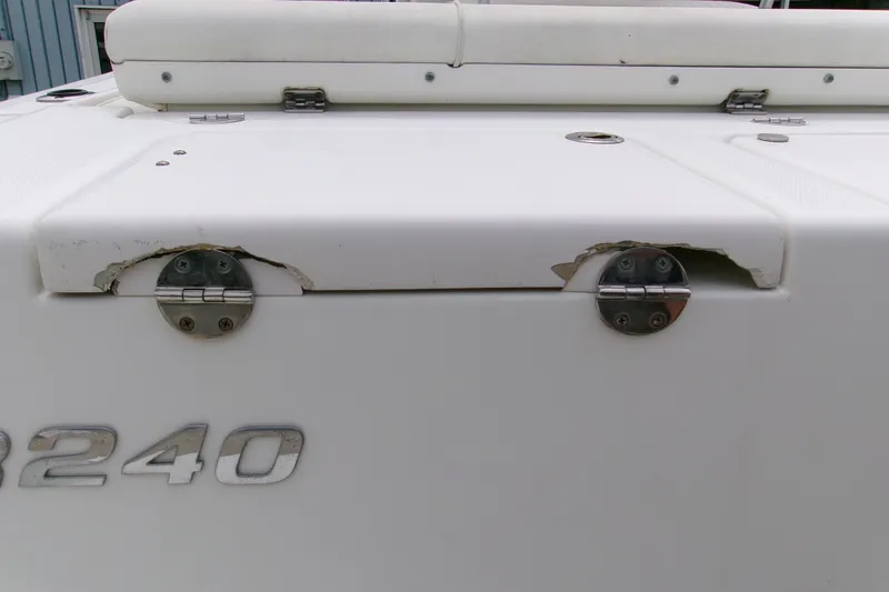 Slide: The Image of 2010 Robalo R240 Center Console boat with visible hinge damage. - 17
