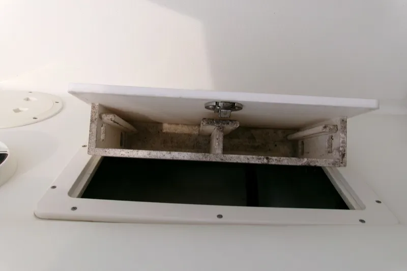 Slide: The Image of Open storage compartment on a 2010 Robalo R240 Center Console boat. - 51