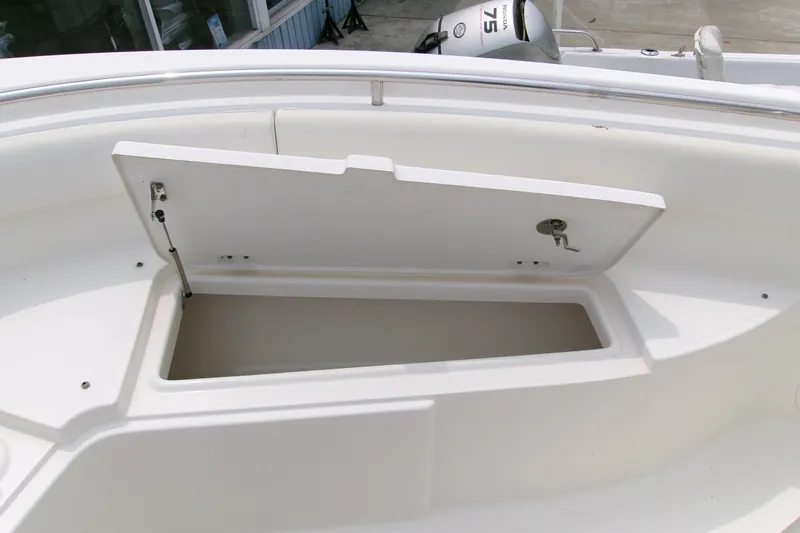 Slide: The Image of 2010 Robalo R240 Center Console boat storage compartment open. - 43