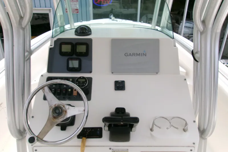 Slide: The Image of 2010 Robalo R240 Center Console boat dashboard with Garmin navigation system. - 12