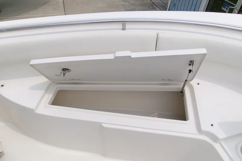 Slide: The Image of Open storage compartment on a 2010 Robalo R240 Center Console boat. - 45