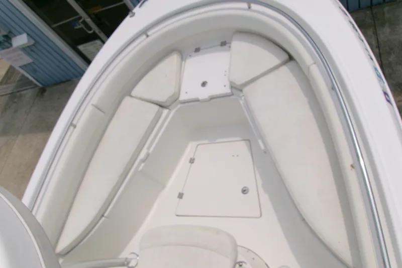 Slide: The Image of 2010 Robalo R240 Center Console boat interior with cushioned seating and storage compartments. - 40