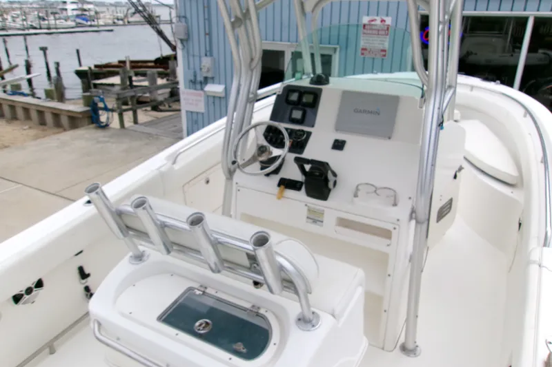 Slide: The Image of 2010 Robalo R240 Center Console boat interior with steering wheel and navigation equipment. - 10
