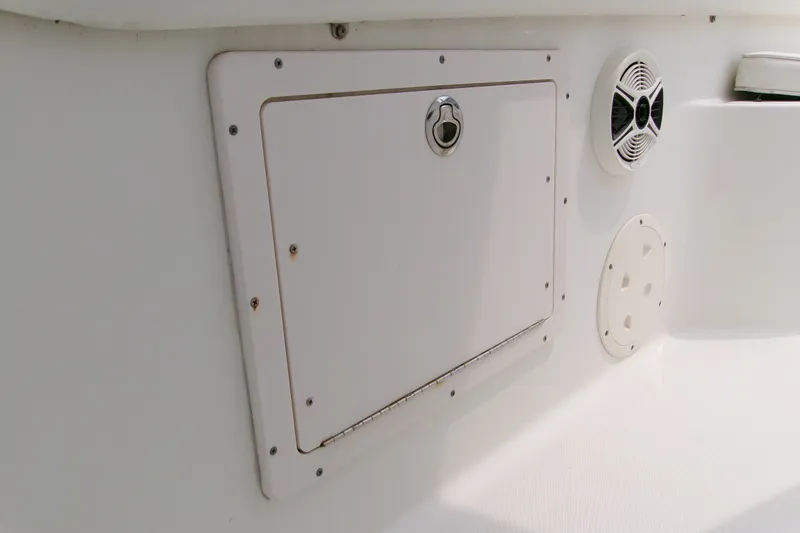 Slide: The Image of 2010 Robalo R240 Center Console boat storage compartment and speaker detail. - 50