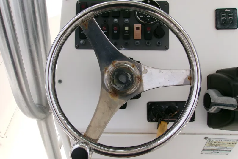 Slide: The Image of Steering wheel and controls of a 2010 Robalo R240 Center Console boat. - 13