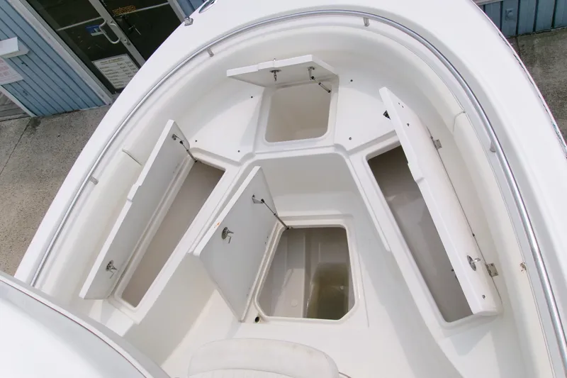 Slide: The Image of 2010 Robalo R240 Center Console boat with open storage compartments on deck. - 42
