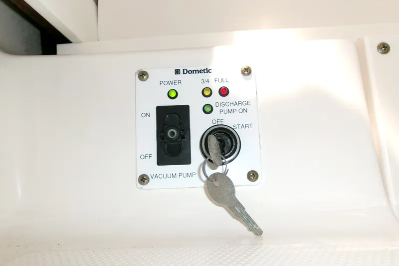 Slide: The Image of Control panel with keys for Dometic vacuum pump on 2010 Robalo R240 Center Console boat. - 38