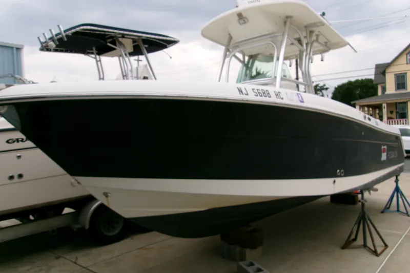 Slide: The Image of 2010 Robalo R240 Center Console boat on stands, parked outdoors. - 0