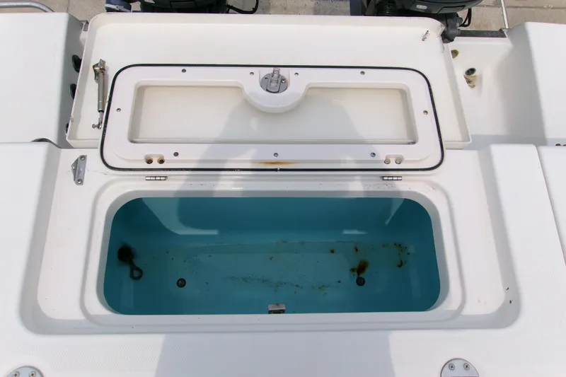 Slide: The Image of Open storage compartment on 2010 Robalo R240 Center Console boat. - 21